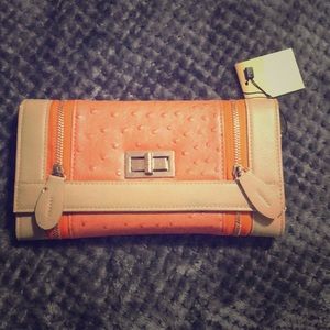 Francesca’s orange two zip clutch